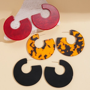Three pairs of C-shaped acrylic hoop earrings in marble red, tortoiseshell, and matte black