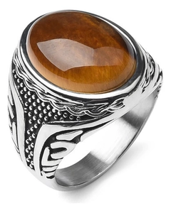 Macro shot of oval tiger eye stone with intricate engraved texture on silver metal ring