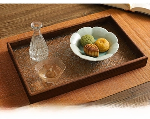 Close-up of retro wooden tray featuring embossed begonia glass and wood grain texture