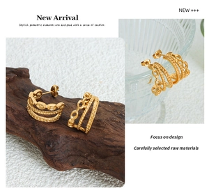 Detail of 18K gold-plated triple-layer C-shaped hoop earrings with textured metal finish