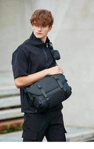 Detail of black tactical messenger bag featuring functional buckles and removable pouch