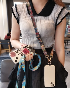 Adjustable crossbody phone strap with vintage geometric patterns and blue cartoon design