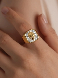 Detailed view of square lion head ring with sparkling crystals in 18k gold plating