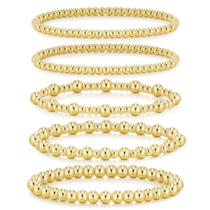 Five-piece stackable gold bead bracelet set with polished metallic finish and elastic bands