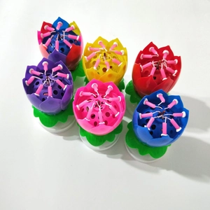 Rotating musical lotus flower birthday candles in multiple colors for cake decoration