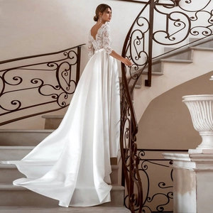 Elegant white lace V-neck wedding dress with satin train and three-quarter sleeves
