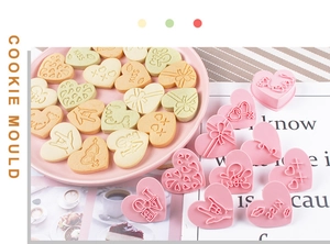 Detail of pink 3D heart cookie molds and colorful Love-themed biscuits with 3D embossed designs