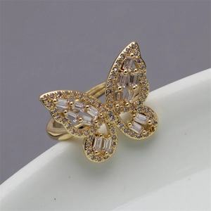 Detailed macro shot of a gold butterfly open ring with sparkling cubic zirconia inlays