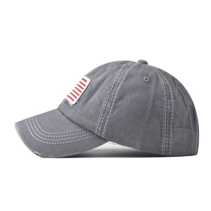 Detail of washed grey cotton baseball cap with American flag red and white stripes patch