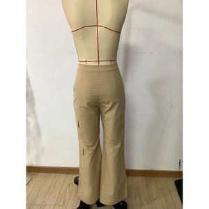 Detailed view of khaki high-waisted cargo pants featuring large side flap pockets