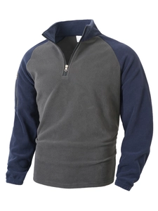 Detail of navy blue and grey fleece sweatshirt featuring half-zip stand collar and size S tag