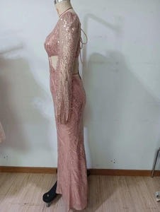 Detail of pink sequin evening gown showing side waist cutout and lace-up back design