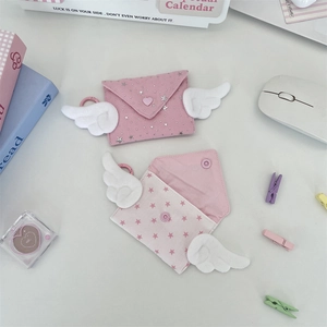 Detail of pink envelope coin purse with plush wings, star print and heart button closure