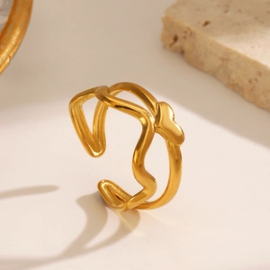Minimalist double-layered gold wave open ring with heart charm on a textured surface