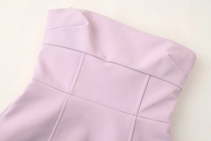 Detail of pink strapless dress bodice with visible stitching and structured seams