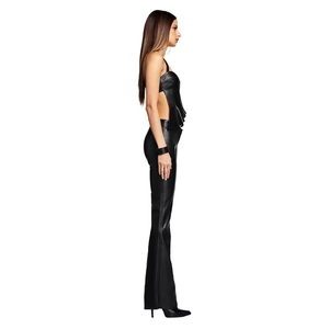 Side view of black faux leather halter top with ruffle hem and flared pants
