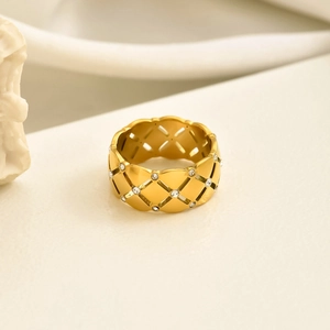 Exaggerated golden stainless steel ring with hollow lattice pattern and zircon stones