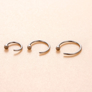 Three sizes of C-shaped stainless steel nose hoop rings with flat disc ends for body piercing