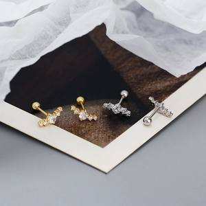 Close-up of gold and silver S925 sterling silver stud earrings with sparkling cubic zirconia