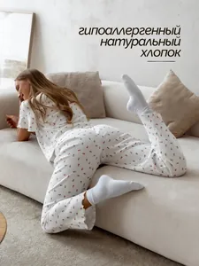 Detail of soft cotton pajama set with red cherry print and delicate ruffled edge finish