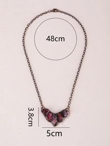 Detail view of vintage bronze V-shaped pendant with natural raw stones and dimensions