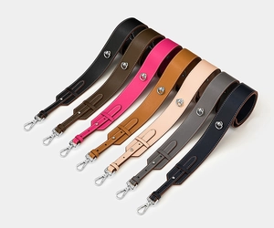 Macro view of adjustable wide leather shoulder straps in seven colors with silver lobster clasps