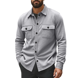 Detail of grey fleece-lined shacket showing texture, contrast buttons and chest pockets