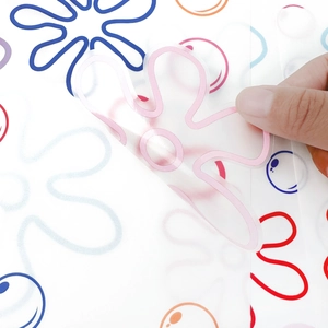 Detailed close-up of a pink flower wall sticker being peeled back to show transparency.