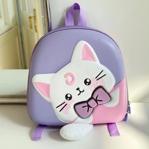 Detail of cute purple cat backpack featuring 3D ears and pink crescent moon emblem
