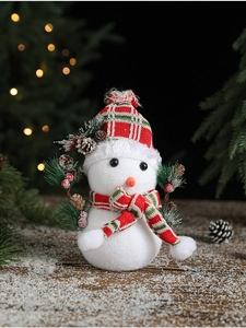 Close-up of white flocked Christmas snowman with red plaid hat and pine cone details