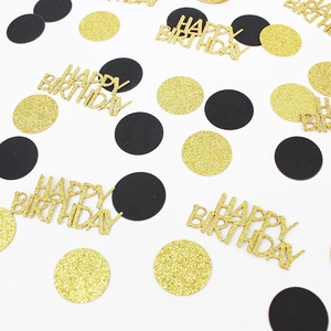 Golden glitter Happy Birthday confetti and black paper circles for party table decoration