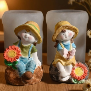Detail of straw hat boy and sunflower girl silicone molds with finished resin dolls