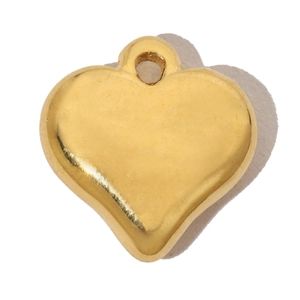 Macro shot of polished gold-finish heart pendant with a metallic ring bail for jewelry diy