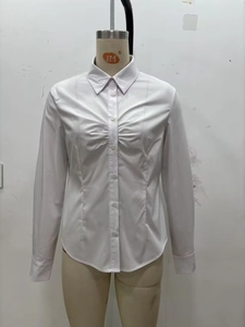 Macro detail of slim-fit white long-sleeve shirt with pleated bust design and turn-down collar