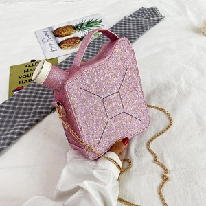 Detail of pink sequin oil drum handbag with golden metal chain strap and white seal cap