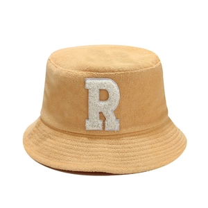 Bright yellow terry cloth bucket hat featuring a large white plush letter R embroidery