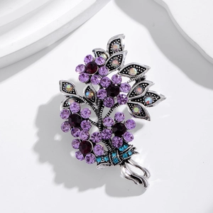 Detail of vintage flower brooch with purple crystals and rhinestones on silver base