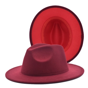 Detail of burgundy fedora hat showing wide brim and bright red contrast interior