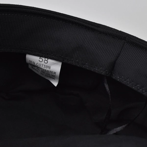 Close-up of leopard chain beret interior showing size 58 label and cotton blend fabric care