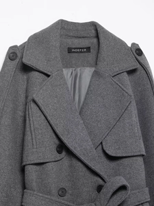 Detailed view of grey wool coat with notch lapels and double-breasted buttons