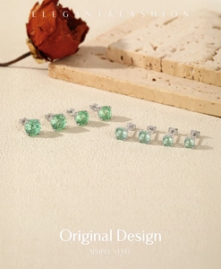 Elegant display of S925 silver stud earrings with sparkling green round gemstones