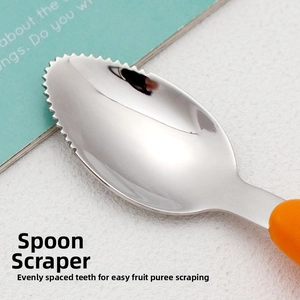 Macro view of stainless steel baby spoon with serrated edges for scraping fruit puree