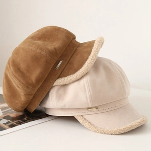 Winter faux suede newsboy hats in caramel and beige with fuzzy fleece trim and metal tag