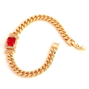 Elegant gold plated bracelet featuring a large rectangular red zircon stone on white background