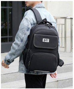 Rear view of a black business backpack on model, showing large capacity and comfortable straps