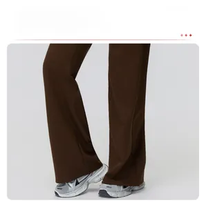 Detail of dark brown wide-leg trousers with elegant drape and relaxed fit style