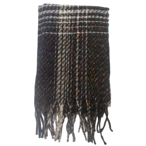 Detail of winter scarf showing colorful plaid pattern and classic fringe tassels