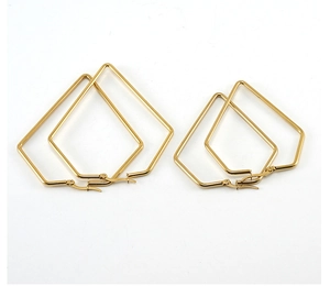 Detail of two sizes of gold geometric rhombus hoop earrings in polished stainless steel