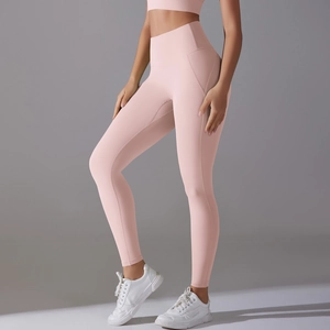 Close-up of high-waist yoga leggings in light pink showing tummy control and lift