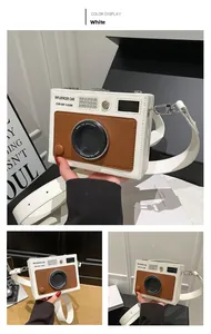 Detail of creative vintage camera-shaped shoulder bag in white and brown PU leather